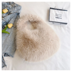 Detailed texture of fluffy faux fur handbag with elegant hobo silhouette and top handle