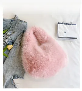Detailed top view of a pink faux fur handbag with a soft, round crescent shape texture