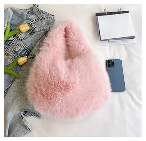 Pink faux fur tote bag showing interior capacity compared with a smartphone