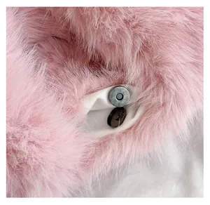 Close-up of the silver magnetic closure on a pink plush handbag with textured metal details