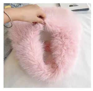 Detail view of pink faux fur bag interior showing spacious and soft plush lining