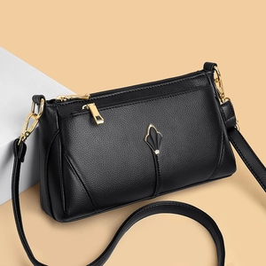 Minimalist black pebble leather shoulder bag with gold metal hardware and water drop decor
