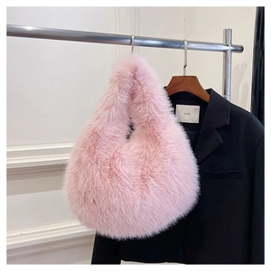 Close-up of pink faux fur texture on a luxury plush handbag with a minimalist design