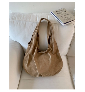 Detailed close-up of camel suede texture and stitching on large capacity tote bag