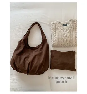 Detail view of large coffee brown suede hobo bag with a matching small zipper pouch