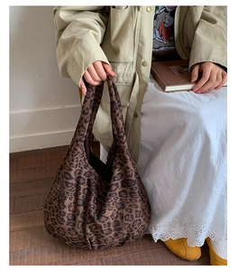 Detail of soft leopard print canvas tote bag featuring classic brown and black patterns