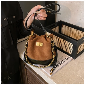 Détail du sac seau vintage avec coutures en losange et fermoir doré à la main