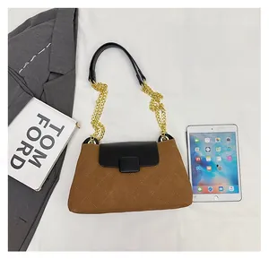 Quilted crossbody bag shown next to a tablet and book for size comparison