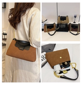 Detailed interior capacity view of quilted crossbody bag with stylish chain strap