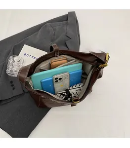Interior view showing large capacity and zipper pocket of brown leather tote bag
