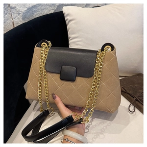 Detail of checkered shoulder bag with gold chain strap and textured brown fabric