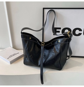 Detail of black PU leather tote with white stitching and vintage crinkle texture