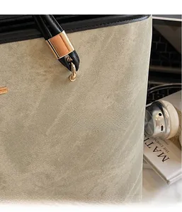 Detail of beige tote bag fabric and leather handle with metal buckle on office desk