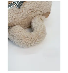 Detail of plush teddy fleece handbag showing the sturdy handle and metal zipper closure