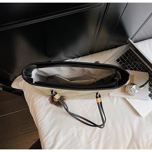 Internal view of a spacious tote bag showing multi-layer compartments and laptop items