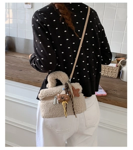 Detail of beige fleece mini bag with cute bear charm and star pendant strap