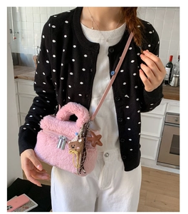 Detail of pink plush mini square bag featuring fluffy faux fur and cute bear charm accessory