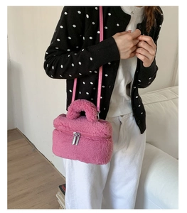Close-up of pink plush mini crossbody bag with fuzzy texture and metal double zippers
