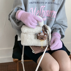 Detail of white faux shearling mini handbag with cute teddy bear charm and leather strap