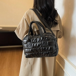 Quilted puffer tote bag in black glossy nylon with adjustable crossbody strap