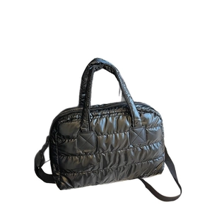 Quilted black puffer tote bag with handles and adjustable crossbody strap for daily use