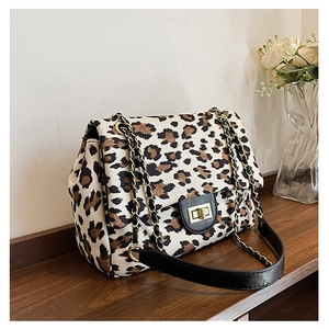 Close-up of leopard print shoulder bag with gold twist lock and elegant leather chain strap