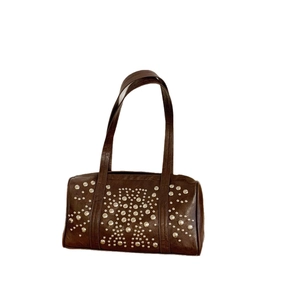 Brown faux leather shoulder bag featuring symmetrical silver rivets and minimalist design