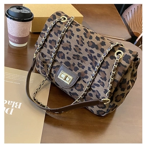 Detail of leopard print chain bag with gold square twist lock and metal hardware