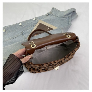 Internal view of leopard print handbag with zip pocket and grey fabric lining
