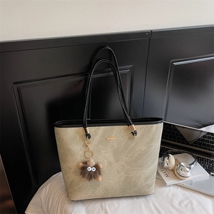 Large capacity tote bag in sage green stone texture with black handles and cute plush charm