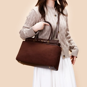 Deep brown matte suede tote bag with leather handles and adjustable shoulder strap for women