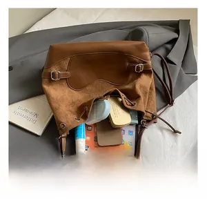 Détails de l'intérieur du sac seau en daim marron montrant sa grande capacité utile