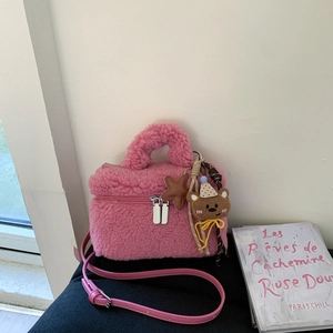 Pink plush crossbody handbag with cute bear charm and double zipper for women