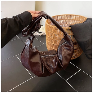 Detailed view of the dark brown shiny leather hobo bag with vintage pleated texture