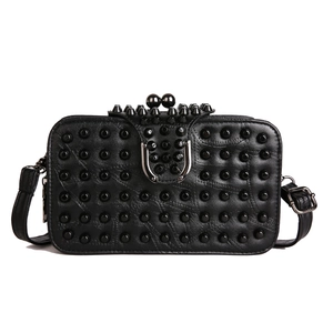 Fashionable black rivet crossbody bag with sphere clasp and punk-style hardware