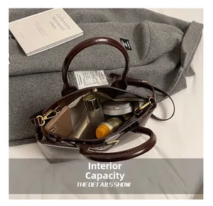 Spacious interior of dark brown leather handbag showing large storage for cosmetics
