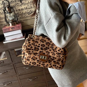 Fashionable leopard print crossbody bag with gold chain strap and metal lock closure
