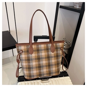 Detail of checkered woolen tote with leather side drawstrings and pebble grain handles