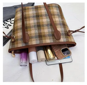 Interior view showing large capacity for tablet and cosmetics in wool plaid tote bag