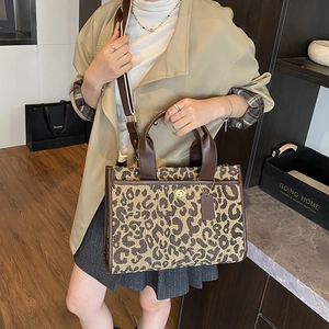 Vintage leopard print tote bag with woven fabric texture and brown leather handles
