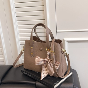 Litchi pattern leather handbag with elegant silk scarf wrap and golden hardware
