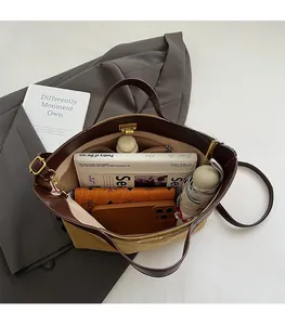 Detail view of large bucket bag interior showing spacious capacity and leather trim