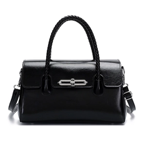 Elegant black glossy leather handbag with woven handle and silver buckle for women