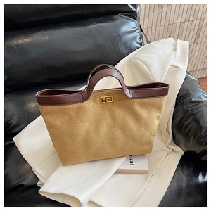 Detailed shot of khaki suede bucket bag with quilted stitching and golden twist lock