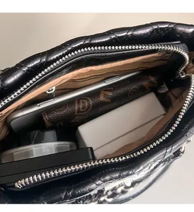 Detailed interior view of quilted black chain bag showing large storage capacity