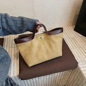 Ginger quilted tote bag with brown leather trim and golden twist lock closure