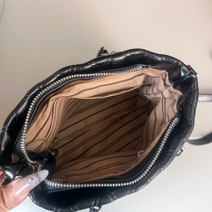 Top view of shiny crocodile pattern bag showing large capacity and striped fabric lining
