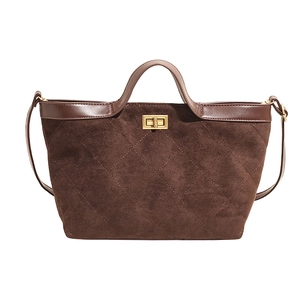 Brown quilted suede bucket bag with gold lock and sleek shoulder strap in retro style
