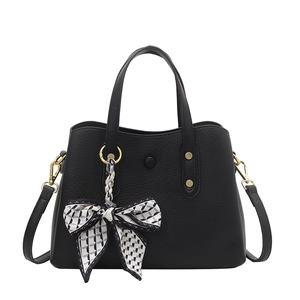 Chic black lychee grain handbag with gold hardware and geometric patterned silk scarf
