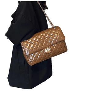 Brown quilted crossbody bag with glossy finish and silver chain strap for women